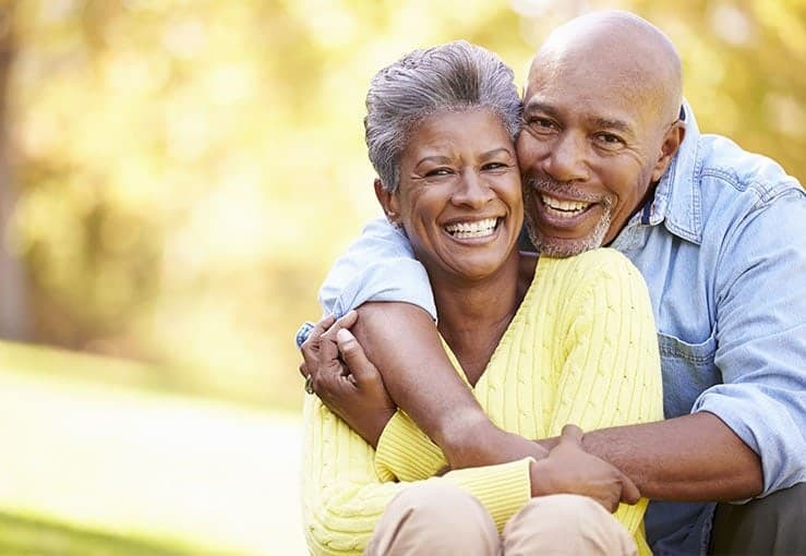Elderly Couple Hugging And Smiling