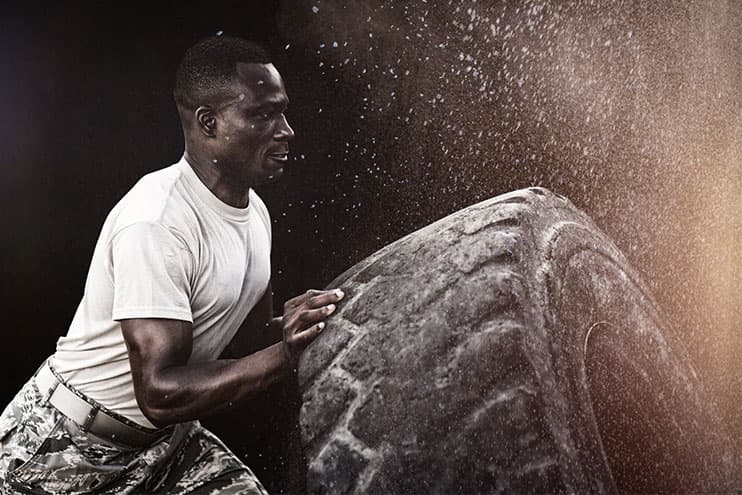 Strong Man Flipping Over A Large Truck Tire