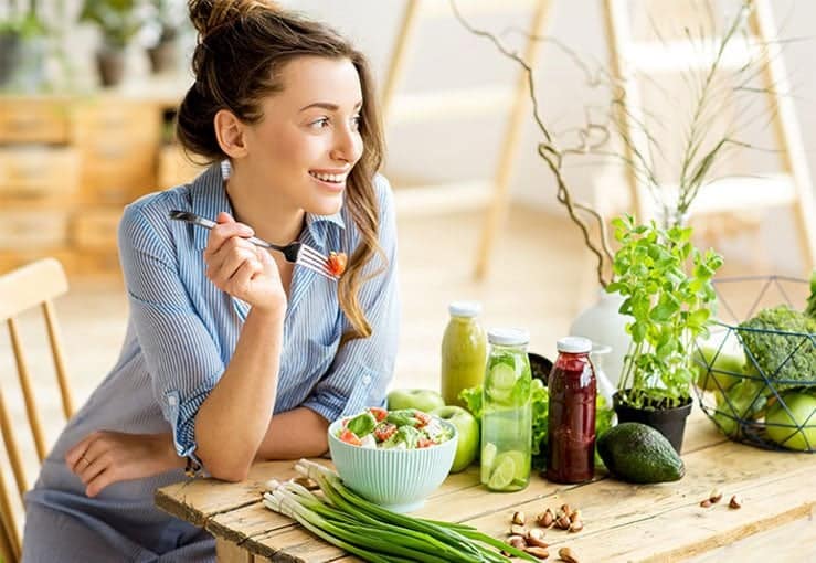 Young Woman Eating Vegetables