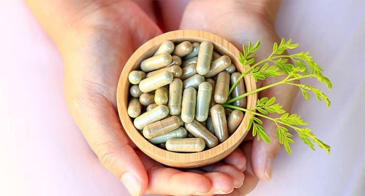 Female Hands Holding A Bowl Full Of Herbal Supplements