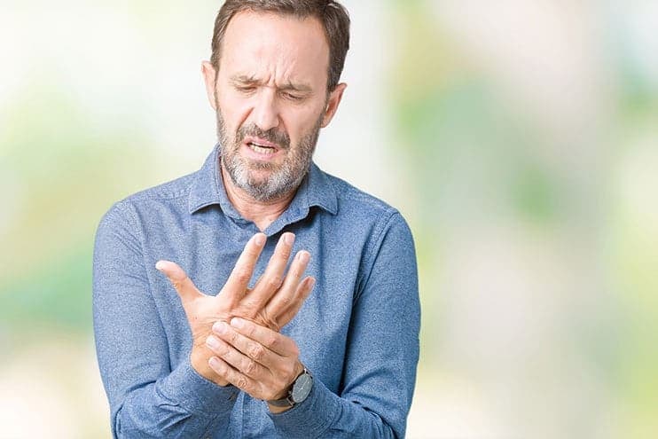 Older Man Feeling Pain In His Hand From Arthritis