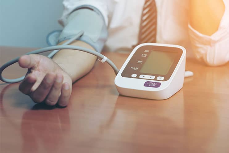 Man Checking His Blood Pressure With Machine