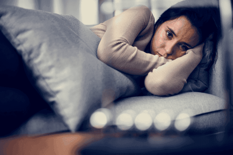 Depressed Woman Laying Down And Hugging Pillow
